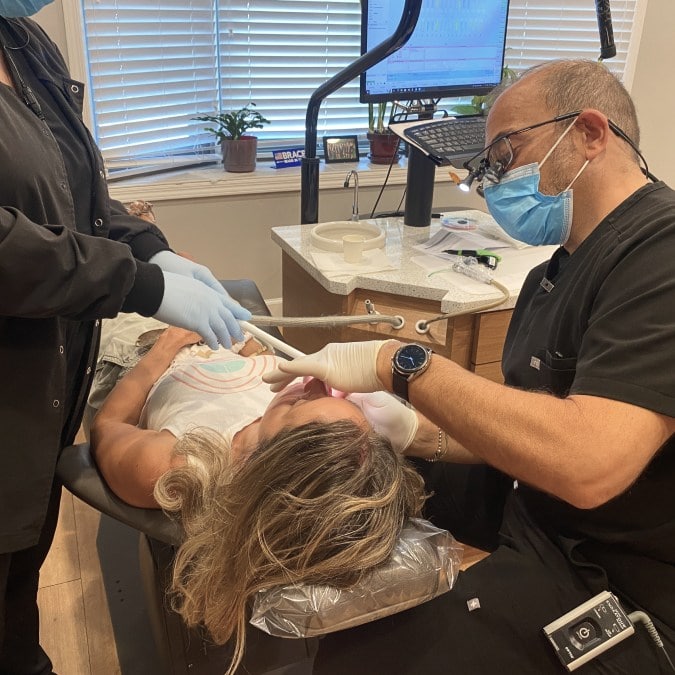 Dr. Peluso works closely with a kids patient