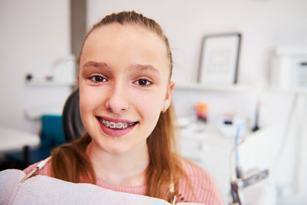 Happy girl showing his braces